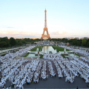 Parisians celebrate the 25th anniversary of Le Dîner en Blanc in 2013, in front of the Eiffel Tower.
